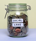 Jar of coins with the label 'social care'